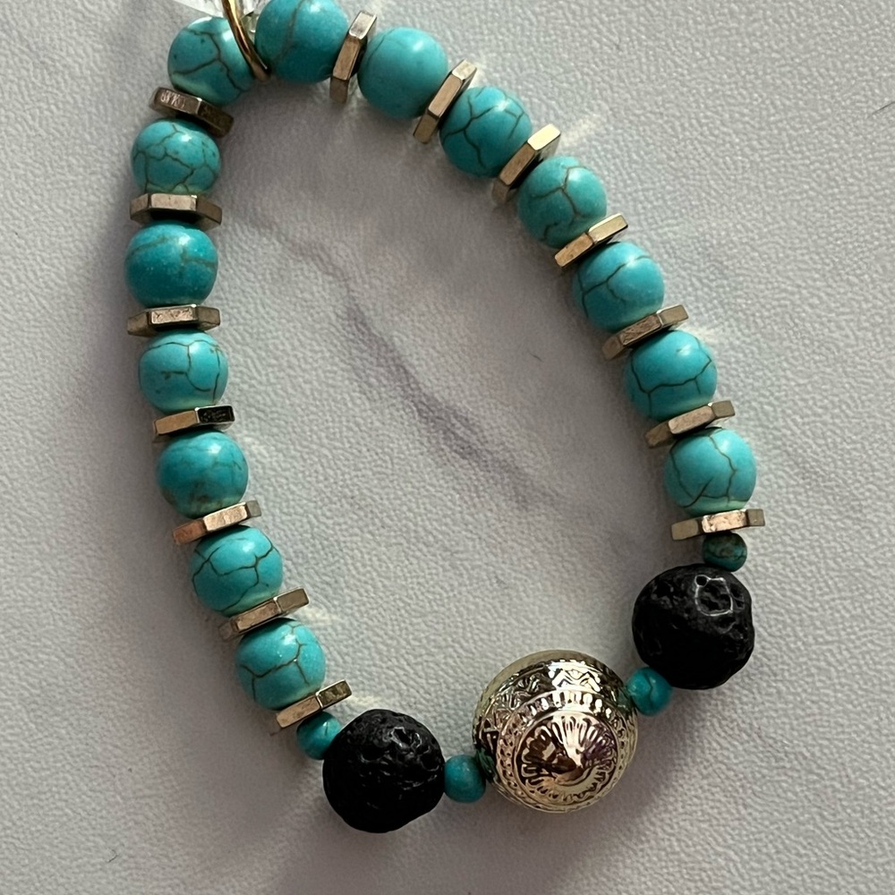 Turquoise howlite and black lava beaded bracelet with gold accents